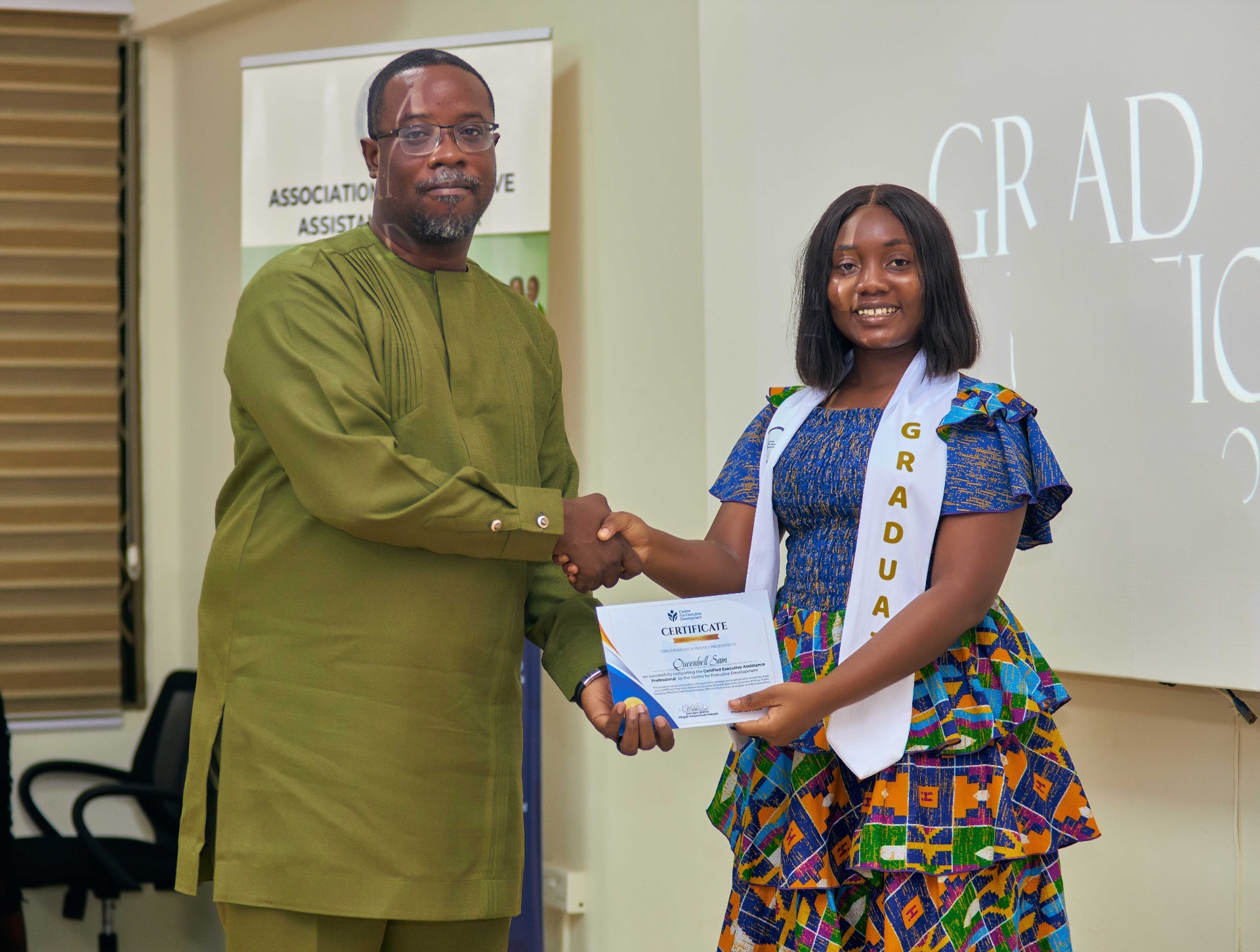 CED graduate receiving certificate on stage