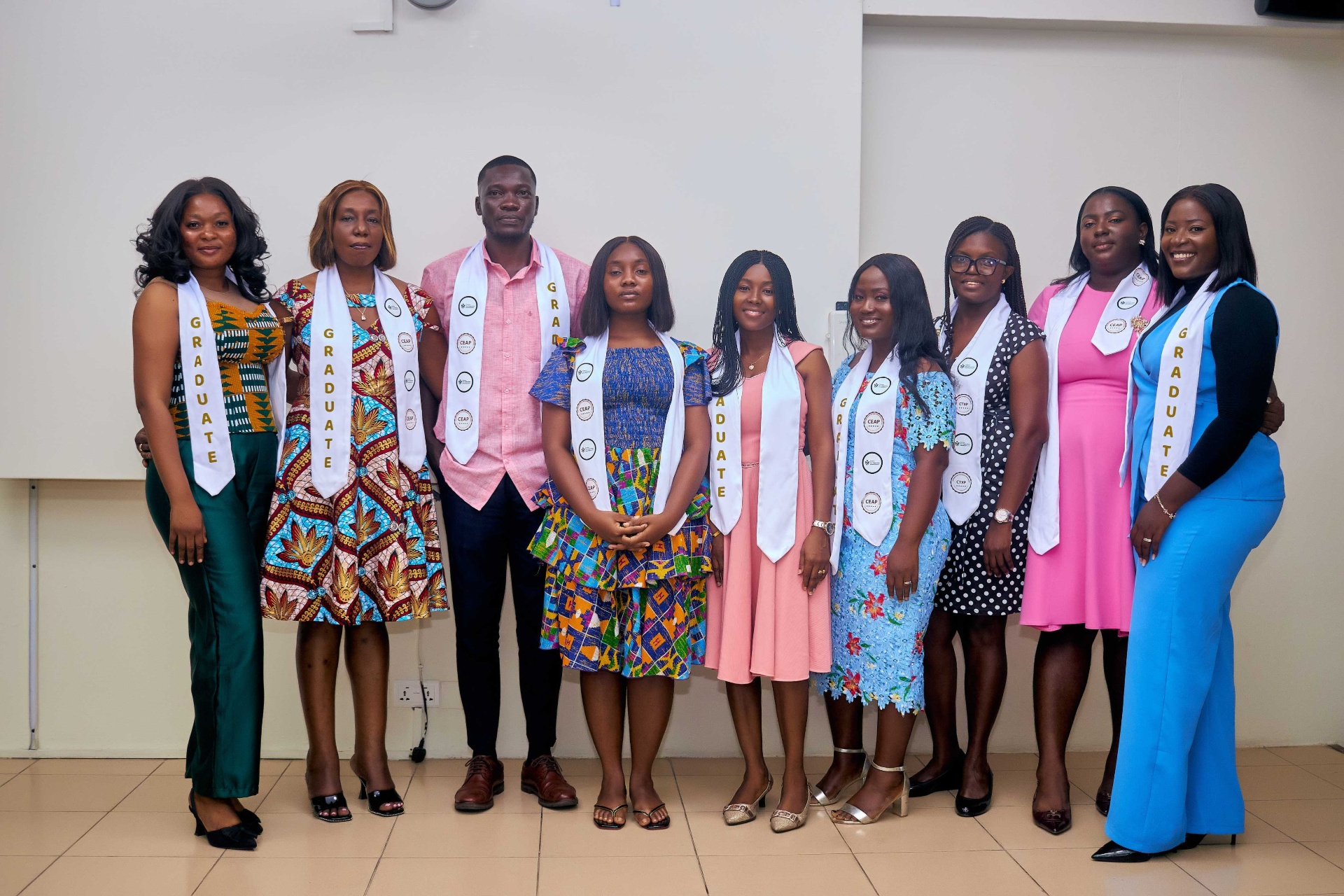 Cohort of CED graduates in formal dress